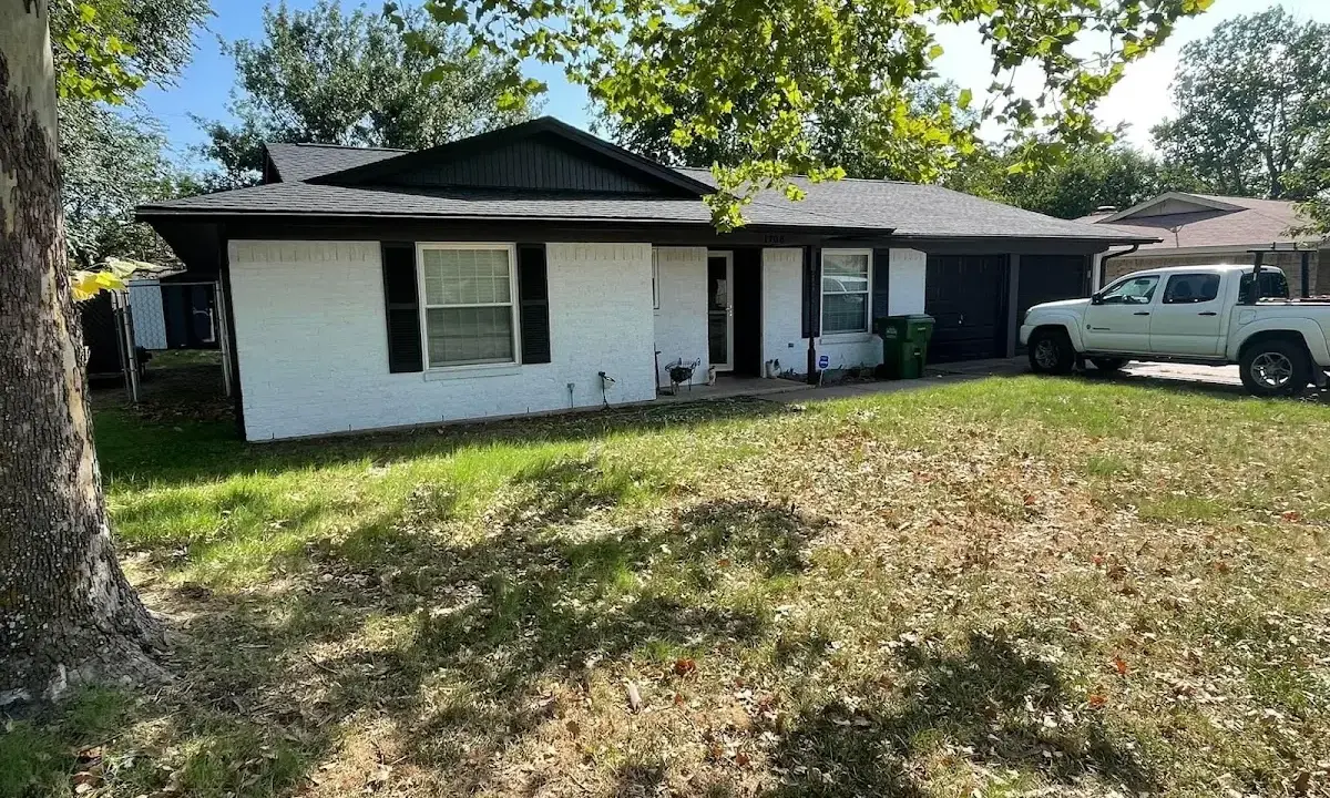Professional roofing crew working on a residential roof in Holmdel